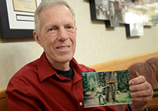 Veteran Charles Condrotte, now retired, holds a picture of himself from when he was a forest ranger. Still an active hiker, he took part in a Phoenix VA study in which he received a kinematically aligned knee replacement.   