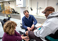  Dr. Ronald J. Triolo and physical therapist Lisa Lombardo work with a Veteran research participant in the VA Motion Study Laboratory in Cleveland. (Photo by Jennifer Kerbo)
