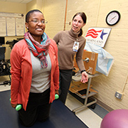 Study participant Raina Groover goes over some exercises with physical therapist Susan Conroy during a clinic visit. 