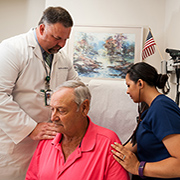 Instructor Dr. Randy Moore (left) and recent nursing graduate Chenoa Leopard meet with Birmingham VA patient 
Kenneth Hollingshead. 