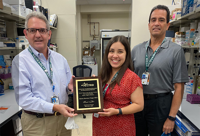 Former CTRID T32 trainee Dr. Marina Martinez-Vargas receiving her graduation award from CTRID Director Dr. Rolando Rumbaut (left) and her primary mentor Dr. Miguel Cruz (right).