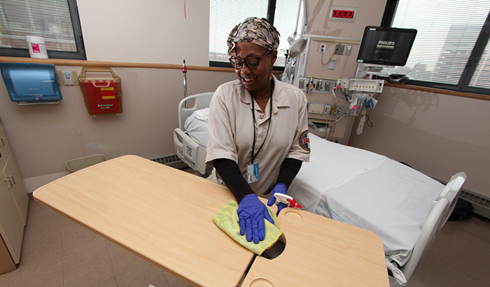 Karen Curtis, with Environmental Services at the Baltimore VA Medical Center, cleans a patient room in the hospital's intensive care unit. (Photo by Mitch Mirkin)  