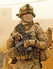 A soldier with the 1st Cavalry Division wears a mask to protect himself from a dust storm in Baghdad, Iraq, in 2009. <em>(Photo by Mass Communication Specialist C 2nd Class Edwin L. Wriston/USN)</em> 