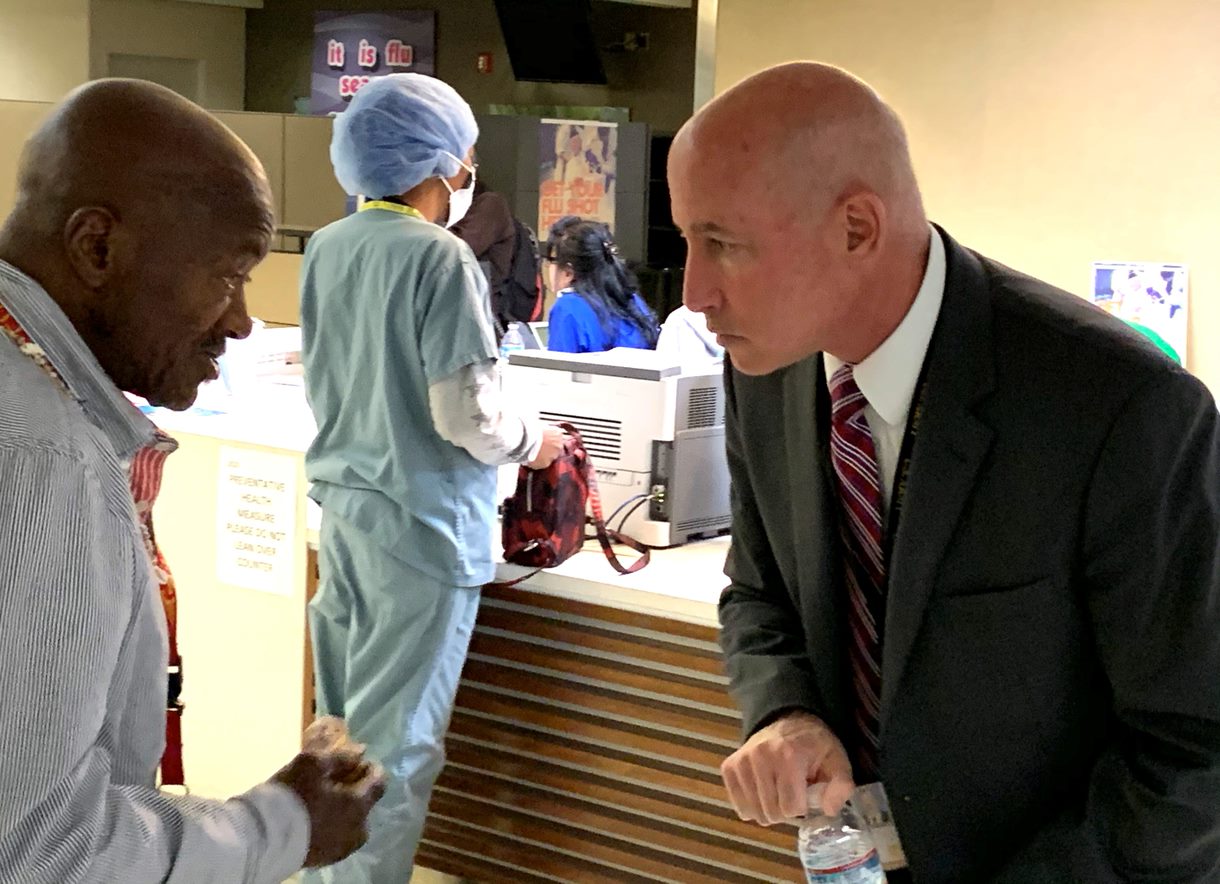 Dr. Steve Braverman (right), director of the VA Greater Los Angeles Healthcare System, speaks with Marine Veteran Jerry Harris about his health care needs. (Photo by Steve Ruh)