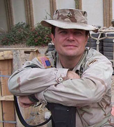Lance Caver takes a break between patrols in Baghdad, Iraq, in 2004
