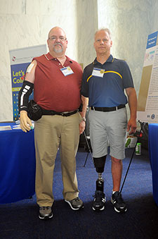 Army Veteran Keith Vonderhuevel (left), who lost an arm in an industrial accident, and Navy Veteran Ben Hutchison, who lost an arm and a leg in a motorcycle crash, joined the event to share their experiences with prosthetics research at the Cleveland VA. (Photo by Robert Williams)  