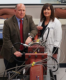 Drs. David Cook and Elaine Peskind use a device called a shock tube (shown in foreground) to simulate blasts in rodent models so they can better understand what happens in the brains of soldiers exposed to blasts. (Photo by Christopher Pacheco) 