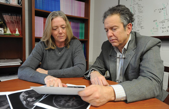 Drs. Regina McGlinchey and William Milberg, directors of VA’s Translational Research Center for TBI and Stress Disorders (TRACTS), review MRIs. (Photo by Frank Curran)  