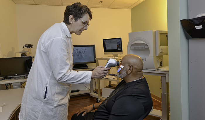 Dr. Machelle Pardue performs an electroretinogram on Army Veteran Michael Brooks, who participated in her study. (Photo by Joey Rodgers)   