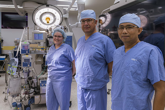  (From left) Drs. Lauren Kennedy-Metz and Marco Zenati and chief perfusionist Rithy Srey stand near a heart-lung machine in an operating room at the West Roxbury VA in Massachusetts. The team is studying how artificial intelligence can help perfusionists optimize use of the machines during cardiac surgery. (Photo by Deirdre Salvas)  