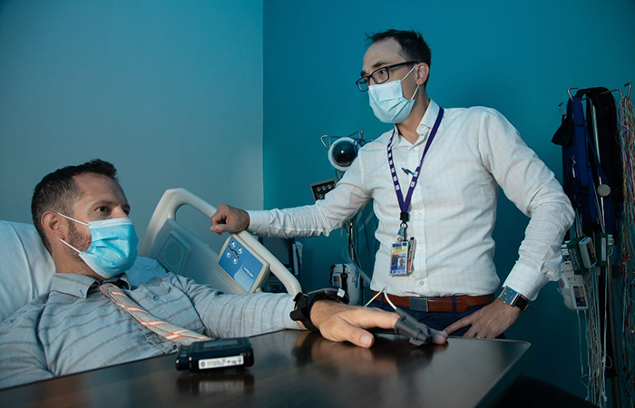Dr. Peter Colvonen (right) studies sleep disorders, among other post-deployment health issues, at the VA San Diego Healthcare System. (Photo by Kevin Walsh)