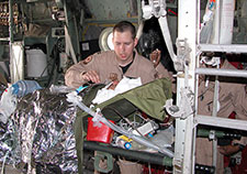  Von Rosenvinge tends to an injured service member aboard a C-130. (Photo courtesy of Dr. Erik von Rosenvinge) 