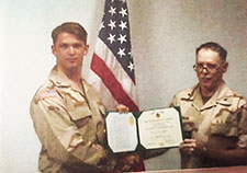 Benzer (left) received the Joint Service Commendation Medal in 1999 while stationed at Eskan Village in Saudi Arabia with the Intelligence directorate of the Joint Task Force-Southwest Asia.   