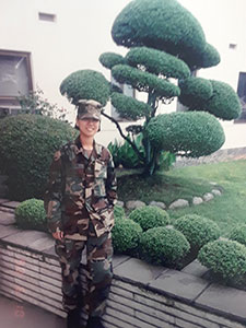 In this 1998 photo, Yani Leyva is outside a building that she and her team were repairing in Camp Zama, a U.S. Army post in Japan.