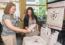Dr. Camille Vaughan (left) and research coordinator Lisa Calas, both with the Center of Excellence for Visual and Neurocognitive Rehabilitation at the Atlanta VA Medical Center, take part in a Research Week event last year. 	