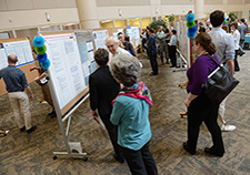  Staff and visitors check out scientific posters during a National VA Research Week event last year at the Minneapolis VA Health Care System. <em>(Photo by April Eilers)</em> 