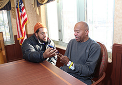  Leon Bryant spends time with his father, Leon Douglas Bryant, at the VA community living center in Baltimore where the elder Bryant now lives. (Photo by Mitch Mirkin) 