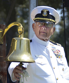Ernest Cowell, an Army, Army Air Corps, and Navy Veteran of World War II, Korea, and Vietnam, rings the ceremonial bell during a 2011 Memorial Day commemoration. 