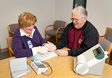 Nurse manager Kelly Johnston checks the blood sugar of a Veteran at the Ann Arbor VA.  