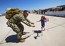 U.S. Navy Petty Officer 2nd Class Brandin Salazar greets his daughter at Naval Base Ventura County following his return from a deployment in the U.S. Pacific Command area of operations. <em>(Photo by CPO Lowell Whitman/USN)</em>
