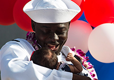  Navy Petty Officer 2nd Class Komla Amewouame meets his daughter for the first time after returning to Pearl Harbor, Hawaii, in December 2015 after a seven-month deployment on the USS Chafee. (Photo by Petty Officer 2nd Class Laurie Dexter/USN