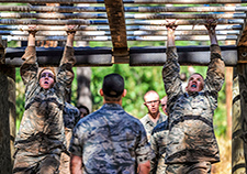 Cadets navigate the monkey bars during basic training at the Air Force Academy in in July 2015. <em>(USAF photo)</em>