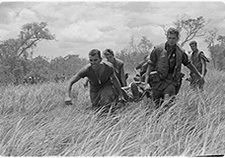 Marines of Company E, 2nd Battalion, 9th Marines, perform a medical evacuation during a heavy firefight with the North Vietnamese Army in July 1967. <em>(USMC photo via Wikimedia Commons) </em>