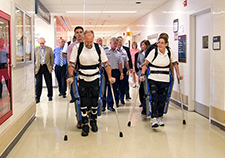 Research participants try out the ReWalk at the Bronx VA Medical Center during a visit by Lt. Gen. Thomas Travis, Surgeon General of the U.S. Air Force. <em>(Photo by Lynne Kantor)</em> 