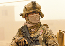 A soldier with the 1st Cavalry Division wears a mask to protect himself from a dust storm in Baghdad, Iraq, in 2009. <em>(Photo by Edwin L. Wriston, U.S. Navy)</em>