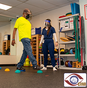 VA Center for Visual and Neurocognitive Rehabilitation research coordinator, Cydney Goodwin Hamel, coaches a participant on traversing balance pods. Regaining balance, motor control, and coordination is an integral aspect of alleviating falls and fall risk in the elderly Veteran population.
